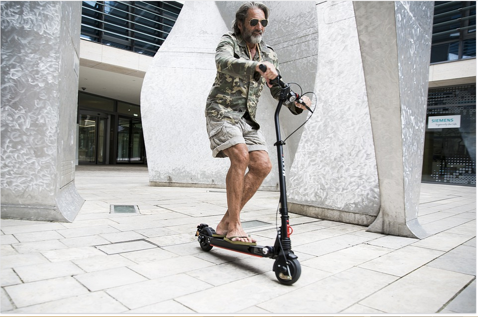 a man riding an e-scooter